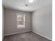 This bedroom features neutral walls, carpet flooring, and a window with blinds for natural light at 5224 Sweet Air Ln, Stone Mountain, GA 30088