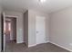 Bedroom showcasing neutral walls, carpet flooring, and a view through an open door to the hallway at 5224 Sweet Air Ln, Stone Mountain, GA 30088