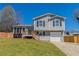 Charming split-level home with a well-maintained front lawn, inviting entry deck, and an attached garage at 5224 Sweet Air Ln, Stone Mountain, GA 30088