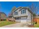 Inviting split-level house featuring a front deck and garage nestled in a vibrant, green neighborhood at 5224 Sweet Air Ln, Stone Mountain, GA 30088
