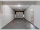 A single-car garage with white walls, a concrete floor, and an overhead garage door at 5224 Sweet Air Ln, Stone Mountain, GA 30088