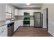 Modern kitchen featuring stainless steel appliances, granite countertops, and white cabinetry for a clean, functional design at 5224 Sweet Air Ln, Stone Mountain, GA 30088