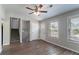 Comfortable living room featuring laminate flooring, natural light, staircase, and access to the front door at 5224 Sweet Air Ln, Stone Mountain, GA 30088