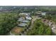 Aerial view of the community, showcasing amenities: tennis courts, playground, pool, lake and baseball field at 557 Winder Trl, Canton, GA 30114