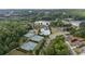 Aerial view showcasing community amenities: pool, tennis courts, playground, and a scenic pond at 557 Winder Trl, Canton, GA 30114