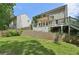 A two-story house with a large yard, wooden deck, and partial brick wall at 557 Winder Trl, Canton, GA 30114