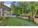 A backyard featuring a lush lawn, fenced area, wooden deck and partial view of a house at 557 Winder Trl, Canton, GA 30114
