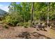 Picture of a wooded backyard with outdoor seating area and stone fire pit at 557 Winder Trl, Canton, GA 30114