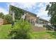 View of a home's lush green backyard with a retaining wall and multi-level wood deck at 557 Winder Trl, Canton, GA 30114