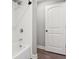 Bathroom with updated shower and tile features updated fixtures and a white door at 557 Winder Trl, Canton, GA 30114
