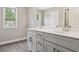 Modern bathroom features a double vanity with sleek countertops and updated fixtures at 557 Winder Trl, Canton, GA 30114