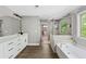 Bright bathroom boasts a double vanity, soaking tub, and separate glass shower at 557 Winder Trl, Canton, GA 30114