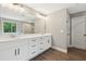 Bright bathroom with a double sink vanity, a large mirror, and a separate shower area at 557 Winder Trl, Canton, GA 30114