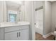 Bathroom with white vanity, modern fixtures, and view of the tub-shower combo at 557 Winder Trl, Canton, GA 30114