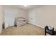 Cozy Bedroom featuring a crib, carpet, closet, and ample space for storage and play at 557 Winder Trl, Canton, GA 30114