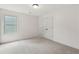 Cozy bedroom with plush carpet and closet has a large window for natural light at 557 Winder Trl, Canton, GA 30114