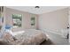 Serene bedroom with neutral tones, carpet, windows overlooking lush greenery, and a comfortable bed at 557 Winder Trl, Canton, GA 30114