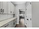 Butler's pantry featuring granite countertops, gray cabinets, subway tile backsplash, and wood flooring at 557 Winder Trl, Canton, GA 30114
