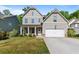 Charming two-story home with a well-maintained lawn and a welcoming front porch and attached two car garage at 557 Winder Trl, Canton, GA 30114