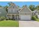 Charming two-story home with a well-manicured lawn and a welcoming covered front porch at 557 Winder Trl, Canton, GA 30114