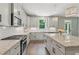 Modern kitchen featuring granite countertops, stainless steel appliances, and stylish lighting at 557 Winder Trl, Canton, GA 30114