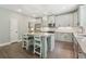 Bright kitchen features a large island with granite countertops, stainless appliances, and stylish pendant lighting at 557 Winder Trl, Canton, GA 30114
