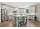 Contemporary kitchen with granite island, stainless steel appliances, and light gray cabinets at 557 Winder Trl, Canton, GA 30114