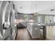 Open-concept kitchen with stainless steel appliances, granite countertops, and a breakfast bar island at 557 Winder Trl, Canton, GA 30114