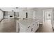 Gourmet kitchen with granite countertops, stainless appliances, and an open layout into the living area at 557 Winder Trl, Canton, GA 30114