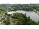 A placid lake surrounded by green trees and some parking space can be seen in this listing photograph at 557 Winder Trl, Canton, GA 30114