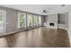 Bright living room boasts hardwood floors, fireplace, built-in shelving, and lots of natural light from several large windows at 557 Winder Trl, Canton, GA 30114