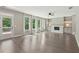 Sun-filled living room with fireplace, hardwood floors, built-in shelving, and access to the outdoor patio at 557 Winder Trl, Canton, GA 30114