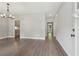 Spacious living room showcasing hardwood floors and access to the kitchen and front door at 557 Winder Trl, Canton, GA 30114