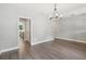 Open-concept living room with hardwood floors and neutral paint at 557 Winder Trl, Canton, GA 30114