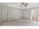 Large main bedroom with tray ceiling, ample space, and an en-suite bathroom at 557 Winder Trl, Canton, GA 30114