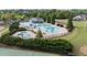 Aerial view of community pool, waterslide, pool house, and landscaped grounds at 557 Winder Trl, Canton, GA 30114