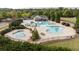 Aerial view of a community pool with a slide, seating, and mature landscaping at 557 Winder Trl, Canton, GA 30114