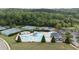 Community pool featuring unique design with slide, kiddie pool, and adjacent tennis courts and playground at 557 Winder Trl, Canton, GA 30114