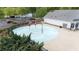 Aerial view of splash pad, pool house, parking lot, and landscaped grounds at 557 Winder Trl, Canton, GA 30114