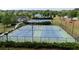 Aerial view of tennis courts with lighting in a well-maintained community at 557 Winder Trl, Canton, GA 30114