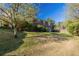 Expansive backyard featuring a lush lawn, mature trees, and a classic brick house, perfect for outdoor enjoyment at 761 Caron Nw Cir, Atlanta, GA 30318