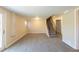 Spacious carpeted basement featuring a staircase to the main level and a walk-out entrance at 761 Caron Nw Cir, Atlanta, GA 30318