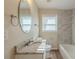 Bright bathroom featuring a granite countertop and tile-surround bathtub at 761 Caron Nw Cir, Atlanta, GA 30318