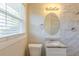 Updated bathroom featuring a marble tiled shower, granite countertop, and oval mirror at 761 Caron Nw Cir, Atlanta, GA 30318