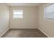 Carpeted bedroom featuring neutral-toned walls, natural light, and two large windows at 761 Caron Nw Cir, Atlanta, GA 30318