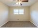 A well-lit bedroom with a ceiling fan, carpet flooring, and a window with natural light at 761 Caron Nw Cir, Atlanta, GA 30318