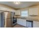 Kitchen featuring stainless steel appliances, granite countertops, and white cabinets with natural light at 761 Caron Nw Cir, Atlanta, GA 30318