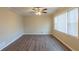 Living room featuring wood-look flooring, neutral paint, white trim, and a ceiling fan at 761 Caron Nw Cir, Atlanta, GA 30318