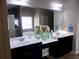 Bathroom featuring double sinks with white countertop and dark cabinetry at 1980 Beyers Landing Dr, Buford, GA 30519