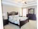Spacious main bedroom with tray ceiling, ceiling fan, and full furniture set at 1980 Beyers Landing Dr, Buford, GA 30519